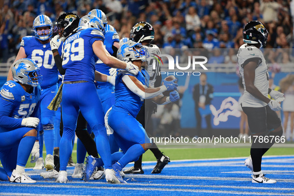 DETROIT,MICHIGAN-November 17: Detroit Lions running back David Montgomery (5) scores a touchdown during the first half of an NFL football ga...