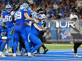 DETROIT,MICHIGAN-November 17: Detroit Lions running back David Montgomery (5) scores a touchdown during the first half of an NFL football ga...