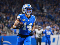 DETROIT,MICHIGAN-November 17: Detroit Lions wide receiver Amon-Ra St. Brown (14) runs the ball for a touchdown during the first half of an N...