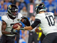 DETROIT,MICHIGAN-NOVEMBER17:  Wide receiver Brian Thomas Jr. (7) of the Jacksonville Jaguars takes the handoff from quarterback Mac Jones (1...