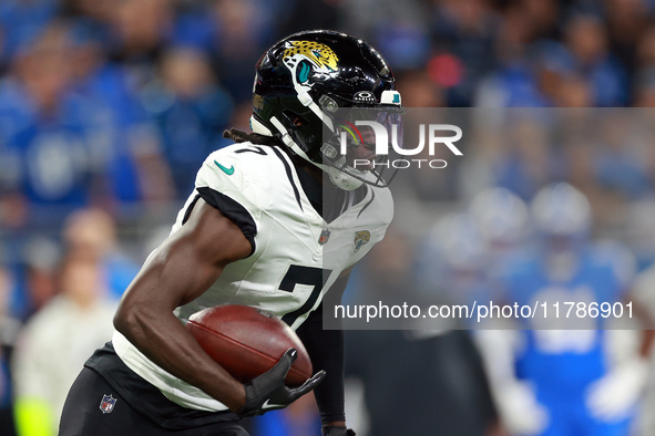 DETROIT,MICHIGAN-NOVEMBER17:  Wide receiver Brian Thomas Jr. (7) of the Jacksonville Jaguars carries the ball for yardage during a game betw...