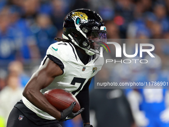 DETROIT,MICHIGAN-NOVEMBER17:  Wide receiver Brian Thomas Jr. (7) of the Jacksonville Jaguars carries the ball for yardage during a game betw...