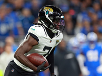 DETROIT,MICHIGAN-NOVEMBER17:  Wide receiver Brian Thomas Jr. (7) of the Jacksonville Jaguars carries the ball for yardage during a game betw...