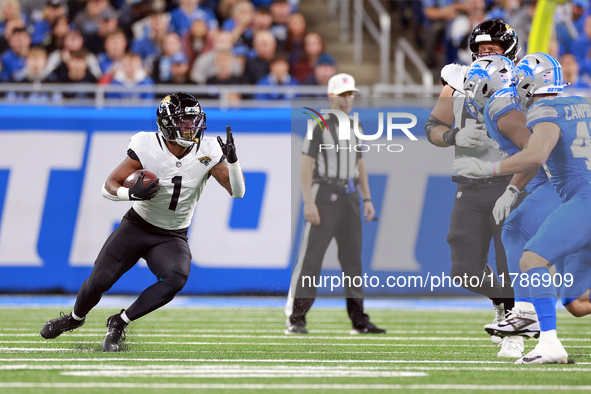 DETROIT,MICHIGAN-NOVEMBER17:  Running back Travis Etienne Jr. (1) of the Jacksonville Jaguars carries the ball during a game between the Det...