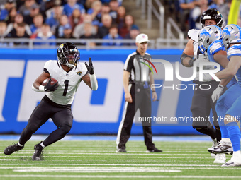 DETROIT,MICHIGAN-NOVEMBER17:  Running back Travis Etienne Jr. (1) of the Jacksonville Jaguars carries the ball during a game between the Det...