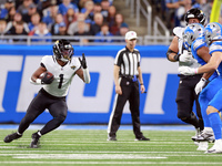 DETROIT,MICHIGAN-NOVEMBER17:  Running back Travis Etienne Jr. (1) of the Jacksonville Jaguars carries the ball during a game between the Det...