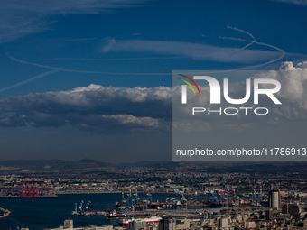 Israeli warplanes leave contrails in the sky above Haifa, Israel, on November 17, 2024. (