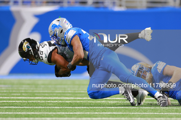 DETROIT,MICHIGAN-NOVEMBER17:  Tght end Brenton Strange (85) of the Jacksonville Jaguars is tackled by safety Brian Branch (32) of the Detroi...