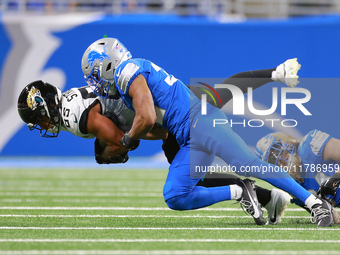 DETROIT,MICHIGAN-NOVEMBER17:  Tght end Brenton Strange (85) of the Jacksonville Jaguars is tackled by safety Brian Branch (32) of the Detroi...