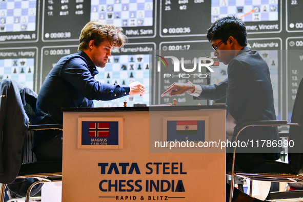 Norwegian GM Magnus Carlsen (L) plays Blitz round chess against Indian GM Rameshbabu Praggnanandhaa (R) during the 6th TATA Steel Chess Indi...