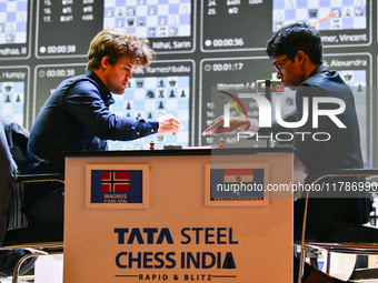 Norwegian GM Magnus Carlsen (L) plays Blitz round chess against Indian GM Rameshbabu Praggnanandhaa (R) during the 6th TATA Steel Chess Indi...