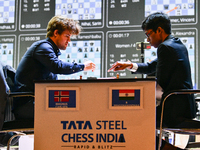 Norwegian GM Magnus Carlsen (L) plays Blitz round chess against Indian GM Rameshbabu Praggnanandhaa (R) during the 6th TATA Steel Chess Indi...