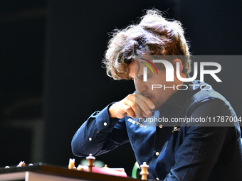 Norwegian GM Magnus Carlsen plays chess during the 6th TATA Steel Chess India Tournament at Dhono Dhanyo Auditorium in Kolkata, India, on No...