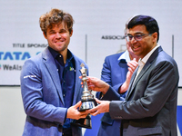 Norwegian GM Magnus Carlsen receives the winning trophy for the ''Blitz round'' chess from Indian GM Viswanathan Anand during the 6th TATA S...