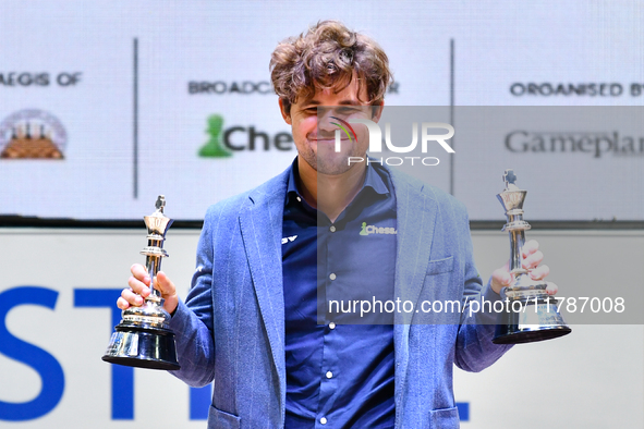 Norwegian GM Magnus Carlsen holds the winning trophies during the 6th TATA Steel Chess India Tournament at Dhono Dhanyo Auditorium in Kolkat...