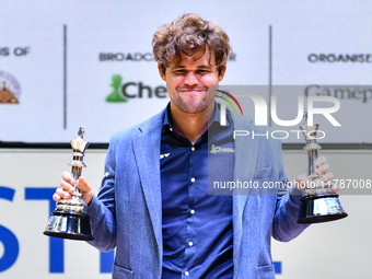 Norwegian GM Magnus Carlsen holds the winning trophies during the 6th TATA Steel Chess India Tournament at Dhono Dhanyo Auditorium in Kolkat...