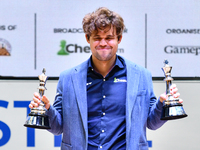 Norwegian GM Magnus Carlsen holds the winning trophies during the 6th TATA Steel Chess India Tournament at Dhono Dhanyo Auditorium in Kolkat...