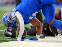 DETROIT,MICHIGAN-NOVEMBER17:  Running back David Montgomery (5) of the Detroit Lions is taken down while carrying the ball during a game bet...