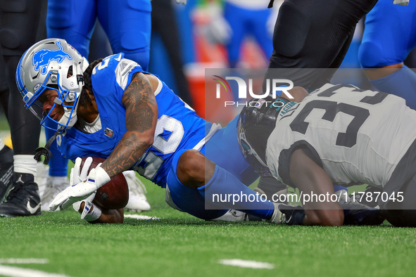 DETROIT,MICHIGAN-NOVEMBER17:  Running back Jahmyr Gibbs (26) of the Detroit Lions is tackled by linebacker Devin Lloyd (33) of the Jacksonvi...