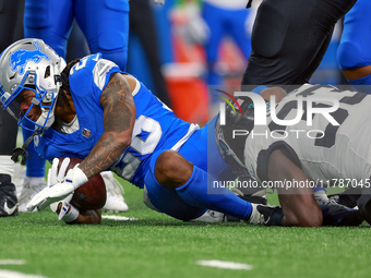 DETROIT,MICHIGAN-NOVEMBER17:  Running back Jahmyr Gibbs (26) of the Detroit Lions is tackled by linebacker Devin Lloyd (33) of the Jacksonvi...