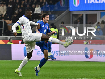 Sandro Tonali (ITA) and Christopher Nkunku (FRA) are in action during the UEFA Nations League Matchday 6 match between Italy and France at t...