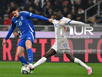 Alessandro Bastoni (ITA) and Randal Kolo Muani (FRA) are in action during the UEFA Nations League Matchday 6 match between Italy and France...