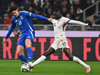 Alessandro Bastoni (ITA) and Randal Kolo Muani (FRA) are in action during the UEFA Nations League Matchday 6 match between Italy and France...