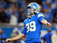 DETROIT,MICHIGAN-NOVEMBER17:  Place kicker Jake Bates (39) of the Detroit Lions follows his successful field goal kick during a game between...