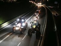 French farmers drive their tractors on the RN118 road at the start of a nationwide protest against the EU-Mercosur agreement, with farmers f...