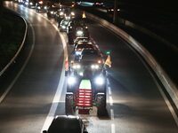 French farmers drive their tractors on the RN118 road at the start of a nationwide protest against the EU-Mercosur agreement, with farmers f...