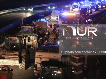 French farmers drive their tractors on the RN118 road at the start of a nationwide protest against the EU-Mercosur agreement, with farmers f...