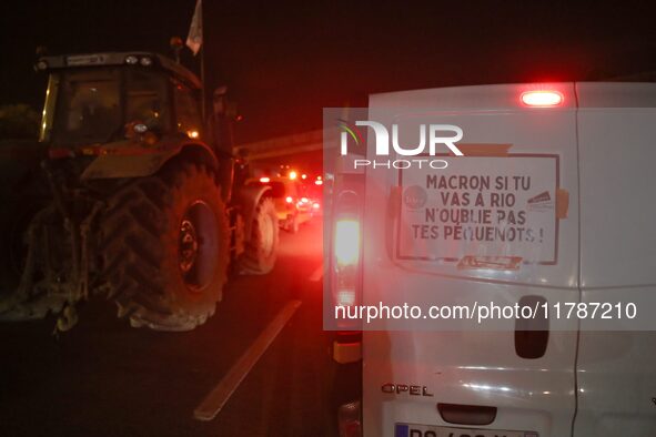 A French farmer drives his car with a banner reading ''Macron if you're going to Rio don't forget your rednecks'' on the RN118 road at the s...