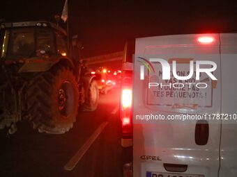 A French farmer drives his car with a banner reading ''Macron if you're going to Rio don't forget your rednecks'' on the RN118 road at the s...