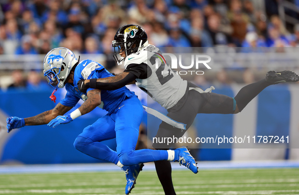 DETROIT,MICHIGAN-NOVEMBER17:  Wide receiver Jameson Williams (9) of the Detroit Lions is stopped by cornerback Ronald Darby (25) of the Jack...