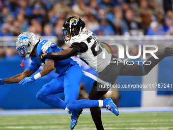 DETROIT,MICHIGAN-NOVEMBER17:  Wide receiver Jameson Williams (9) of the Detroit Lions is stopped by cornerback Ronald Darby (25) of the Jack...