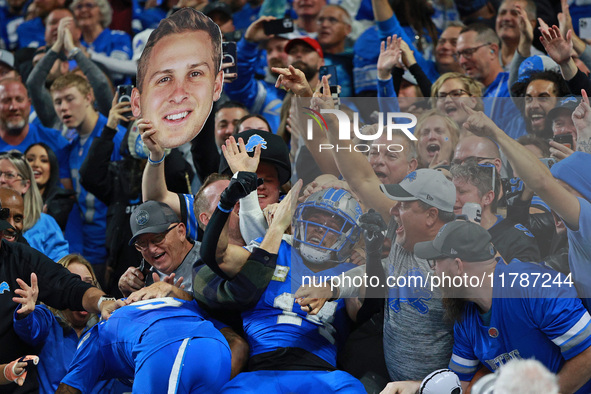 DETROIT,MICHIGAN-November 17: Detroit Lions wide receiver Amon-Ra St. Brown (14) celebrates with fans after scoring a touchdown during the s...