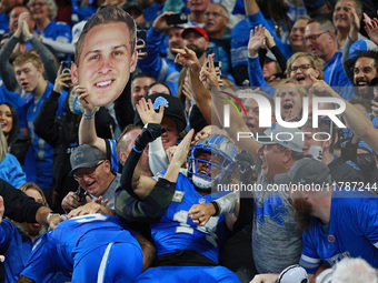 DETROIT,MICHIGAN-November 17: Detroit Lions wide receiver Amon-Ra St. Brown (14) celebrates with fans after scoring a touchdown during the s...