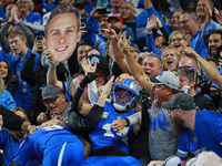 DETROIT,MICHIGAN-November 17: Detroit Lions wide receiver Amon-Ra St. Brown (14) celebrates with fans after scoring a touchdown during the s...