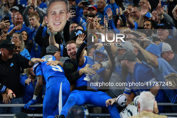 DETROIT,MICHIGAN-November 17: Detroit Lions wide receiver Amon-Ra St. Brown (14) celebrates with fans after scoring a touchdown during the s...