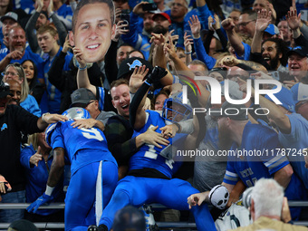 DETROIT,MICHIGAN-November 17: Detroit Lions wide receiver Amon-Ra St. Brown (14) celebrates with fans after scoring a touchdown during the s...