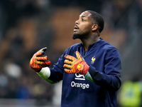 Mike Maignan of France gestures during the UEFA Nations League 2024/25 League A Group 2 match between Italy and France at Stadio Giuseppe Me...