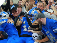 DETROIT,MICHIGAN-November 17: Detroit Lions wide receiver Amon-Ra St. Brown (14) celebrates with fans after scoring a touchdown during the s...