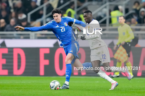 Randal Kolo Muani of France and Alessandro Bastoni of Italy compete for the ball during the UEFA Nations League 2024/25 League A Group 2 mat...