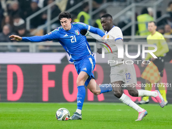 Randal Kolo Muani of France and Alessandro Bastoni of Italy compete for the ball during the UEFA Nations League 2024/25 League A Group 2 mat...