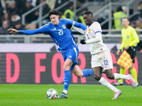 Randal Kolo Muani of France and Alessandro Bastoni of Italy compete for the ball during the UEFA Nations League 2024/25 League A Group 2 mat...