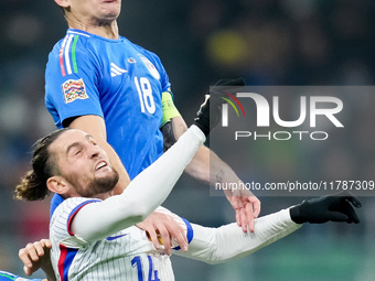 Nicolo' Barella of Italy and Adrien Rabiot of France jump for the ball during the UEFA Nations League 2024/25 League A Group 2 match between...