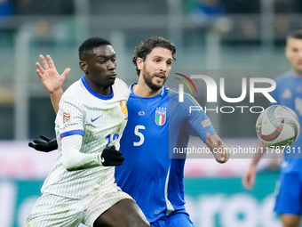 Randal Kolo Muani of France and Manuel Locatelli of Italy compete for the ball during the UEFA Nations League 2024/25 League A Group 2 match...