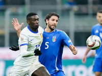 Randal Kolo Muani of France and Manuel Locatelli of Italy compete for the ball during the UEFA Nations League 2024/25 League A Group 2 match...