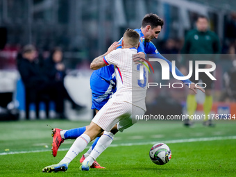 Andrea Cambiaso of Italy and Lucas Digne of France compete for the ball during the UEFA Nations League 2024/25 League A Group 2 match betwee...