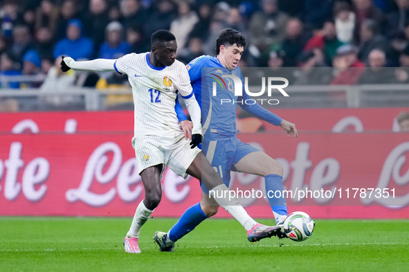 Alessandro Bastoni of Italy and Randal Kolo Muani of France compete for the ball during the UEFA Nations League 2024/25 League A Group 2 mat...